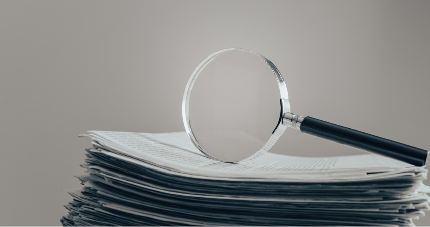 Magnifir on newspaper stock photo