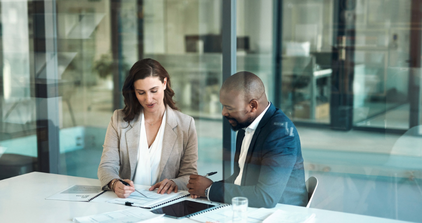 Office, meeting and documents of business people, clients or team for taxes, audit or revenue report in accounting