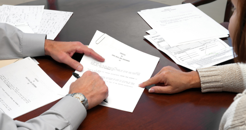 A woman making a formal business agreement signing a will
