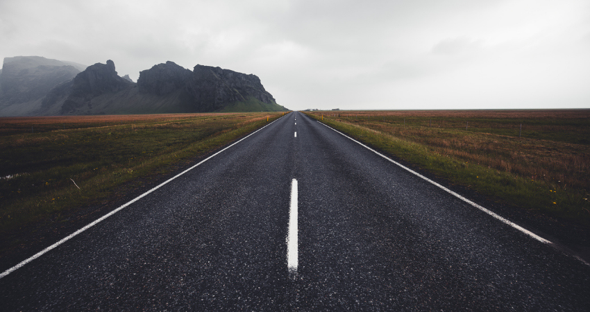Endless road traveling through an empty Iceland landscape