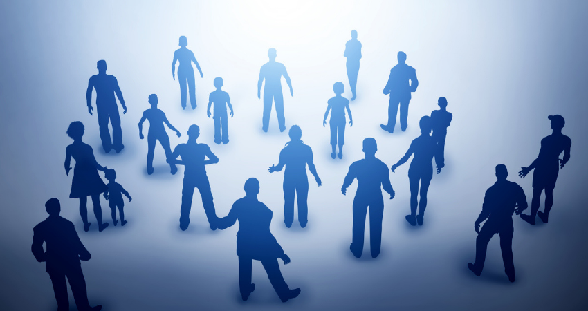 Group of various people silhouettes looking towards light, future